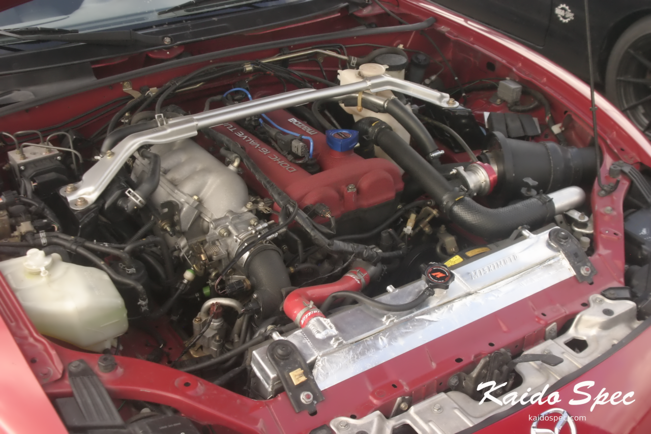 The engine bay of the above Mazdaspeed.  Featuring what the community calls "Joes Intake" after the creator, a larger front mount intercooler, and Mishimoto radiator.